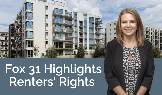 Female attorneys standing in front of apartment buildings